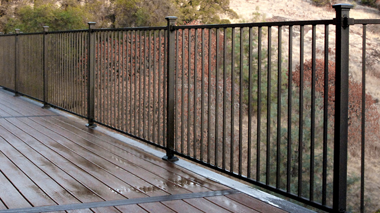 Fortress Fe26 Iron Panel Railing System installed with Collar Brackets and Flat Pyramid Post Caps - Black Sand