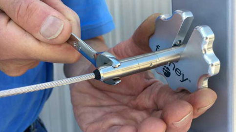 A Feeney Cable Rail tools help tighten a cable during installation.