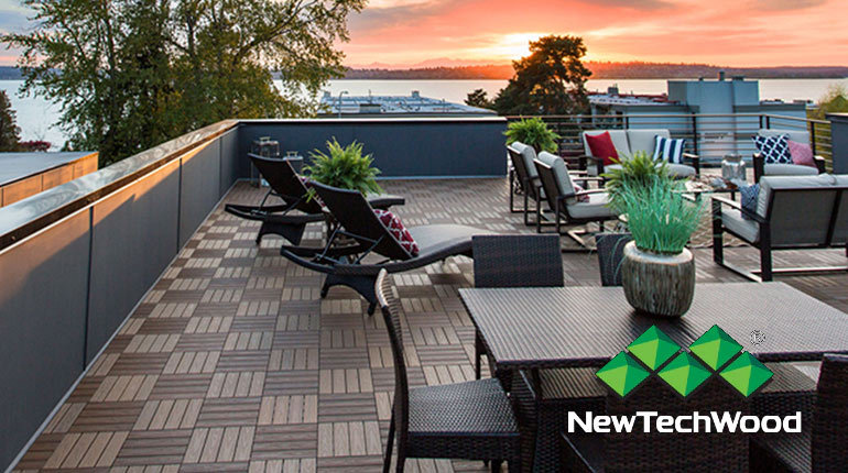 NewTechWood composite tiles creates a beautiful rooftop patio overlooking the sunset on a lake.