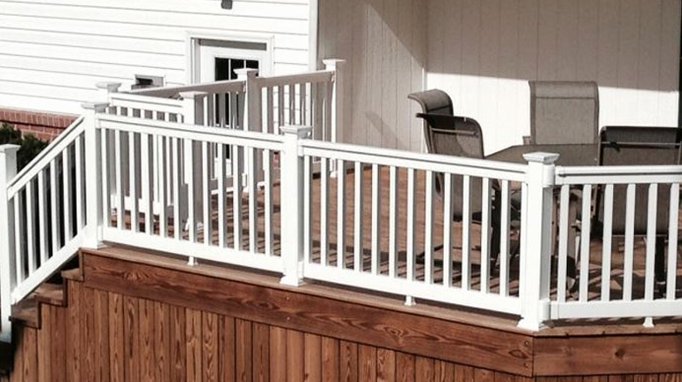 Harrington Railing by Durables in White accents the house and provides safety on the patio.