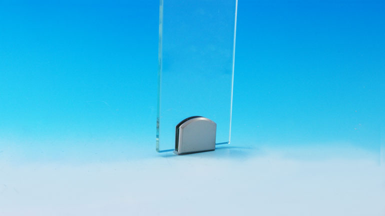 Fortress glass baluster clip on a blue and white background.