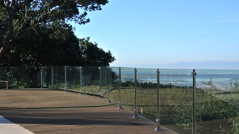 A Invisirail Glass Railing provides a clear view of the waterfront and provides the protection of a railing system.