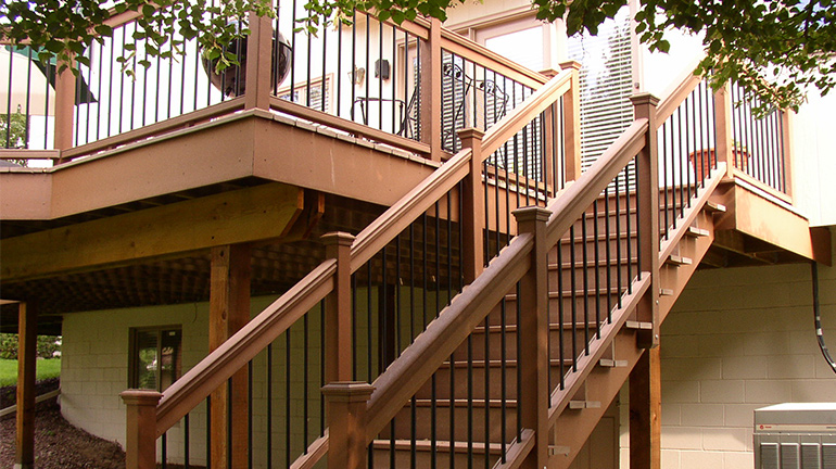 Vintage Series Round Iron Balusters installed between two wood rails.