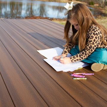The Envision Ridge Premium line of composite decking, shown in Vintage Oak, creates a clear open space for the whole family to enjoy.