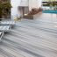 Create a comfortable, open space with the inviting look of Barrette Siesta decking in Garapa Gray.