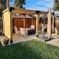 An extended pergola creates a large, expansive sitting area for your backyard