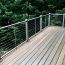 AFCO Pro's distinctive breadloaf top rail creates a classic deck railing look