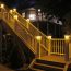Bring out the beauty of your deck at night with Solar Post Cap Lights for Trex Transcend Post Sleeves by Ultra Bright. Shown with Amber light function on.