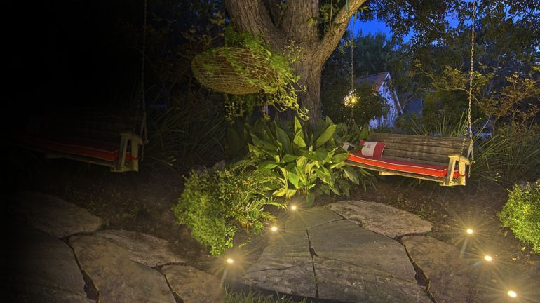 Small ground lights highlight an outdoor space