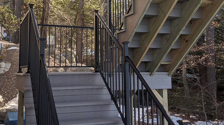 A sturdy steel railing with the traditional Fortress FE26 Colonial Accent Top Rail