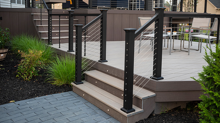 Modern Key-Link vertical cable railing on deck stairs