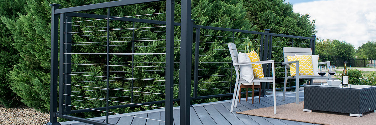 Fortress Horizontal Cable Railing in Black with modern deck furniture on a grey deck