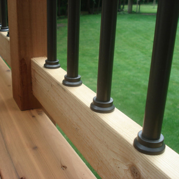 Close up of 
Designer Baluster Connectors by Deckorator installed on a cedar railing