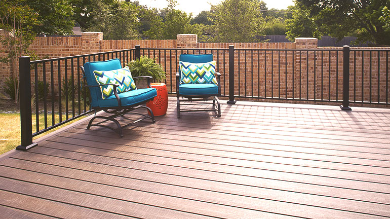 a composite deck with Fortress AL13 Metal railing and bright deck funiture