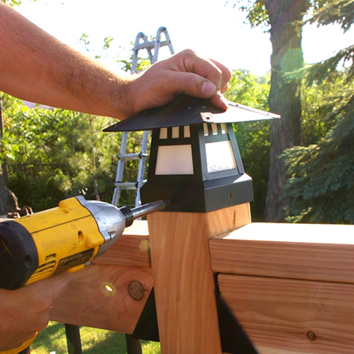 securing post cap deck light with supplied screws