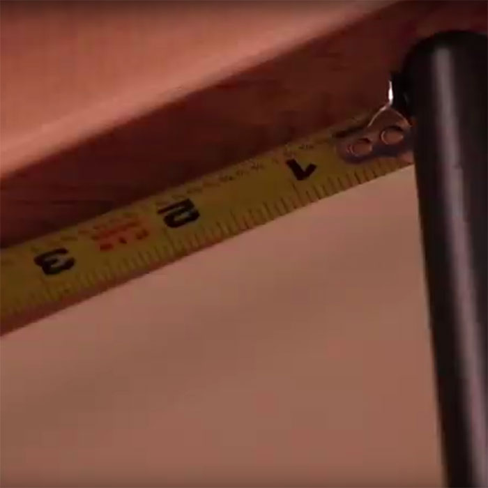 a closeup of a tape measurer figuring out where to install a rail light
