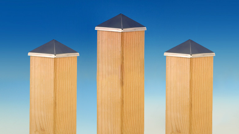 Three 4x4 cedar posts in front of a blue gradient background showcase Aluminum Post Points by Deckorators in a Stainless finish