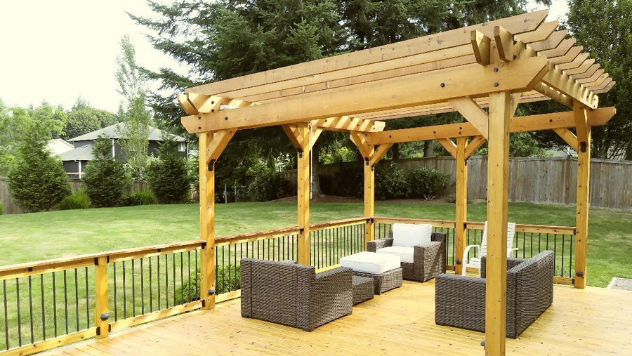 A revamped wood deck with a gorgeous pergola and metal balusters