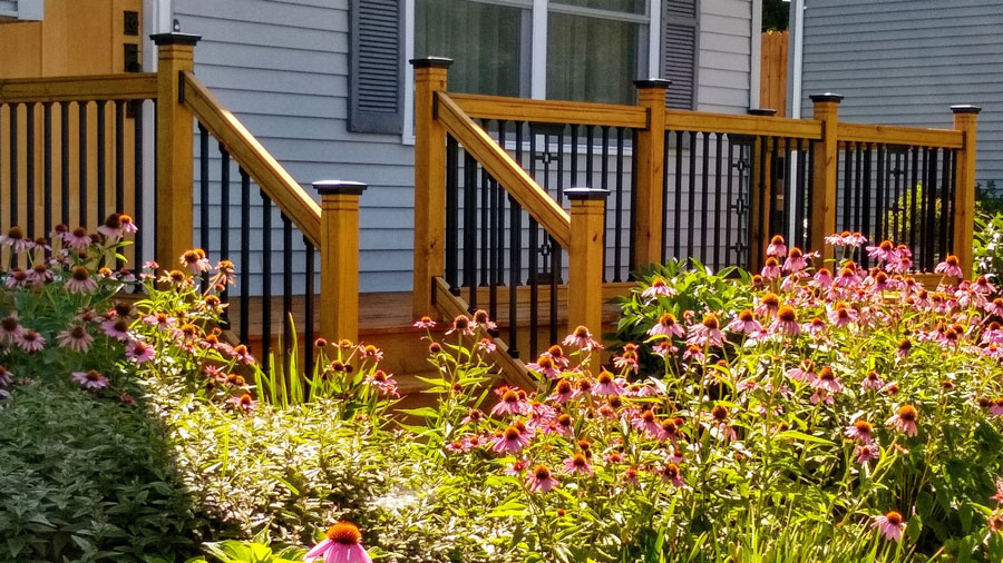 A wood deck railing refreshed with sleek balusters and post caps