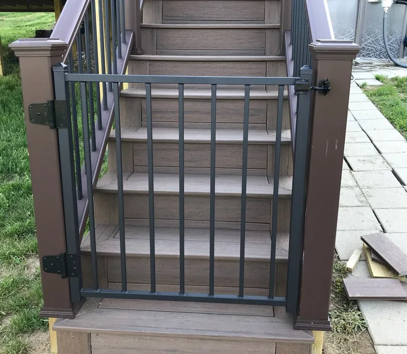 A gate securing the bottom of deck stairs