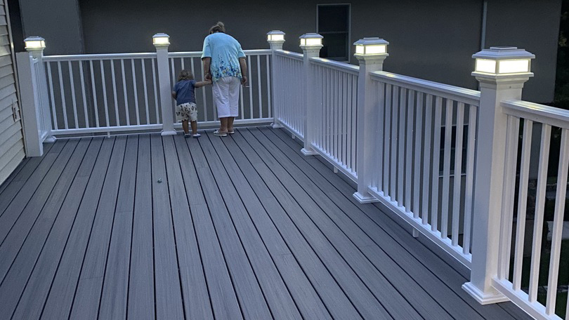 Lighted post caps create a cozy deck space