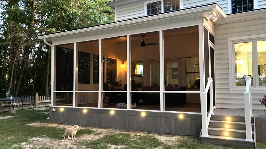 A lighted screen porch with fascia lighting to illuminate a dog's path along the house