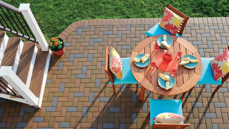 An eye-catching multicolored paver pattern on a ground-level deck