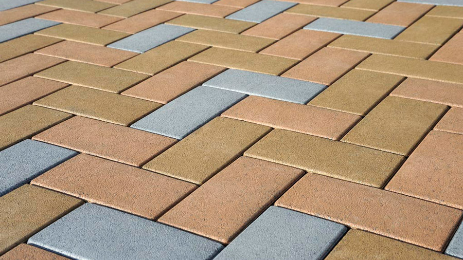 A close shot of a multi-colored deck paver pattern made from Aspire Pavers