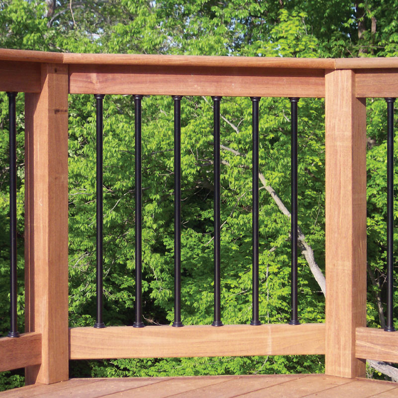 A wood deck railing with round balusters and baluster connectors