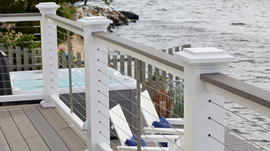 A square-edged deck board shown on top of a deck railing as a drink rail