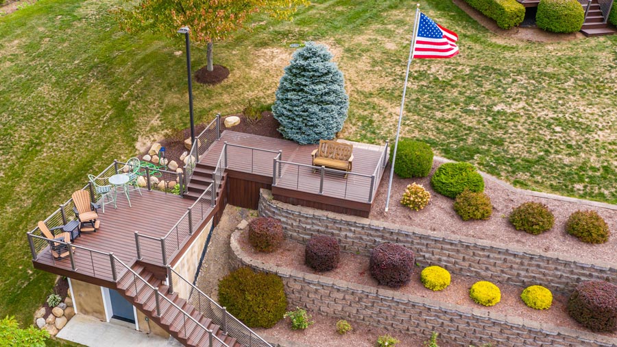 An American flag flies over a lakeside deck with American-made Key-Link railing