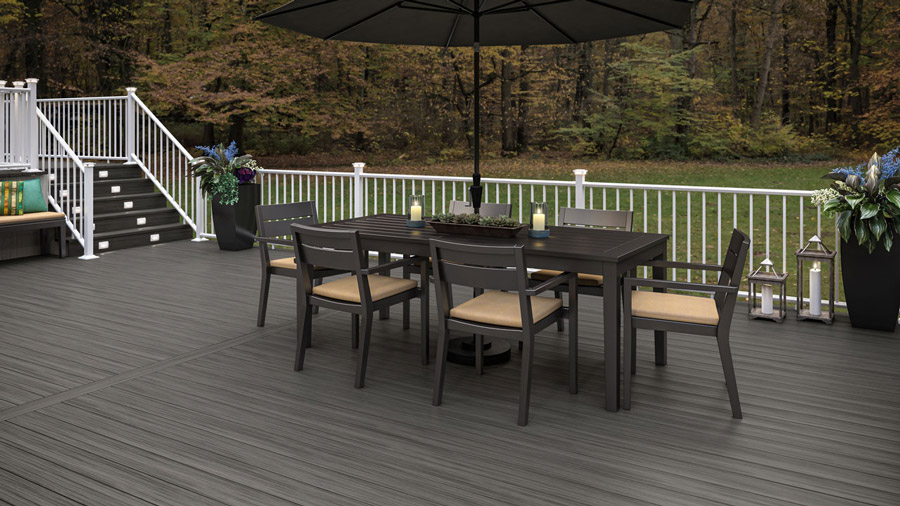 A dark brown mineral-based composite deck with white railing