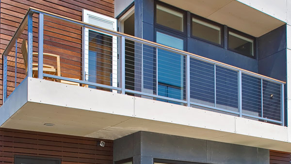 A deck with stainless steel posts on its cable railing, created with Feeney Custom DesignRail