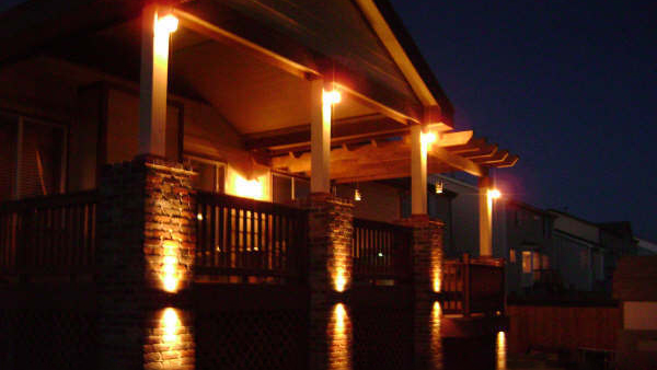 A porch lit up by Peak to Peak deck lighting