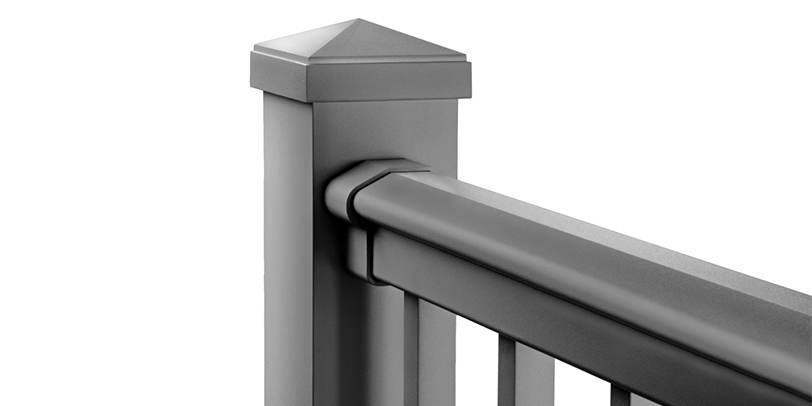 A metal rail attached to a post via railing brackets