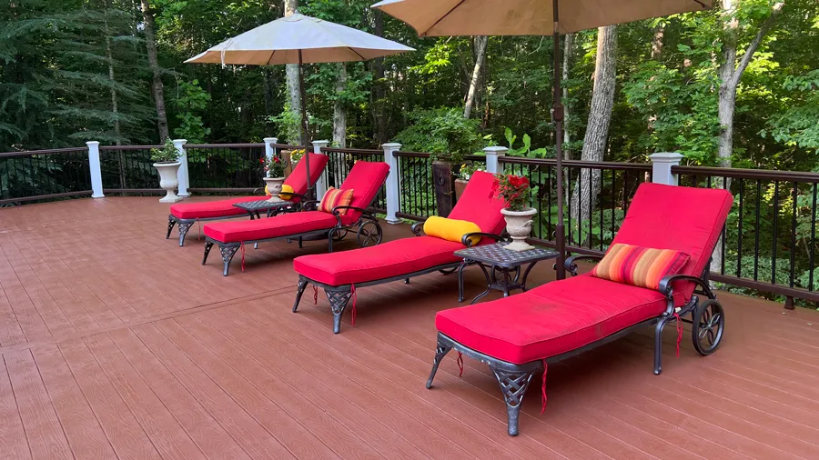 A warm red deck made from composite boards that mimic the color blend of natural cedar deck boards