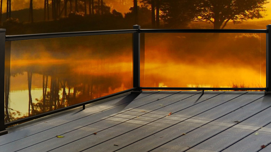 An AFCO Glass Deck Railing overlooking water at sunrise