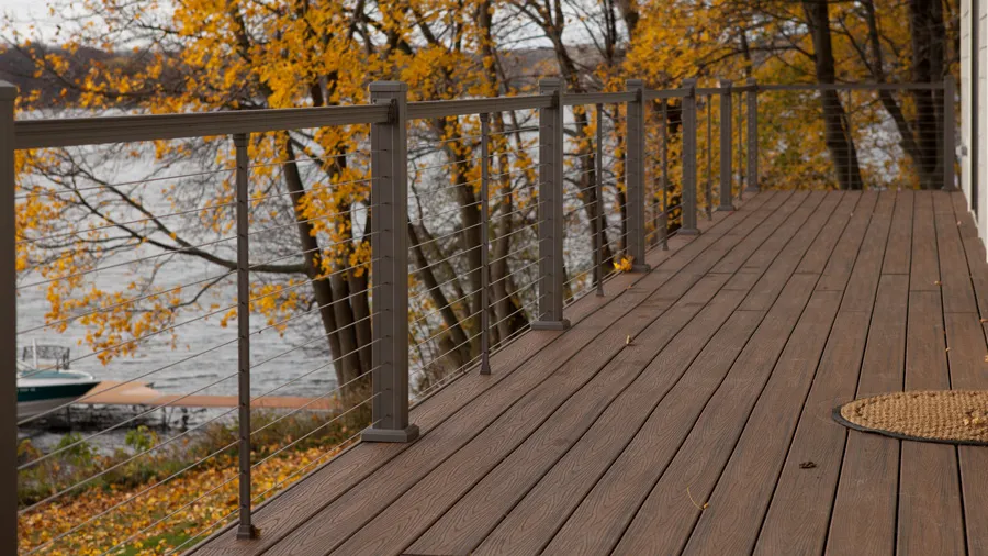 A deck with a smattering of leaves on its surface during the fall season