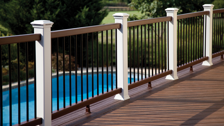 A length of Trex Transcend deck railing overlooking a pool on a luxurious deck