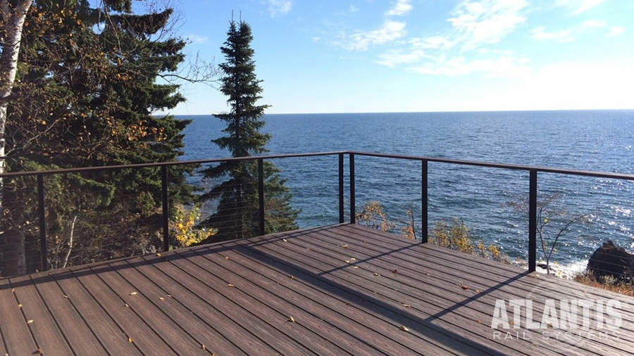 A trim Atlantis Spectrum Cable Railing system disappears into a lake view