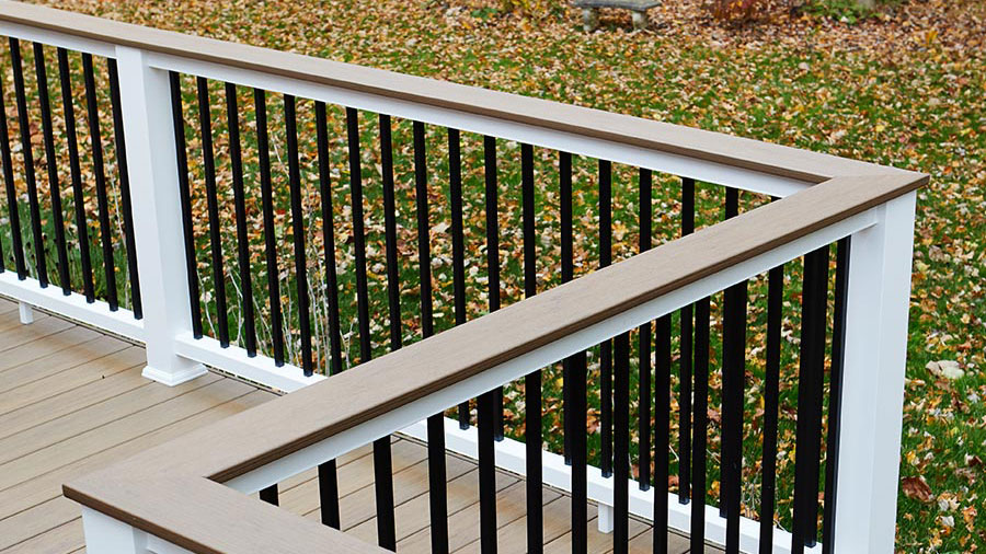 A classic composite railing with a deck board as a cocktail rail}}