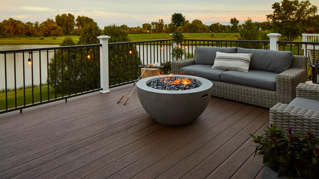 The natural look of reclaimed wood comes with TimberTech Composite Reserve decking, shown in Dark Roast