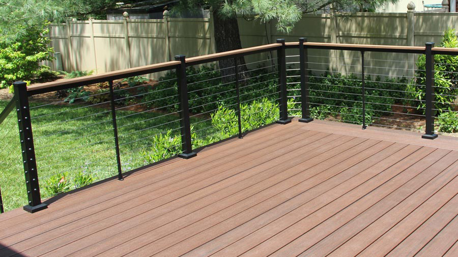 A deck with Skyline Cable Railing and a deck board drink rail