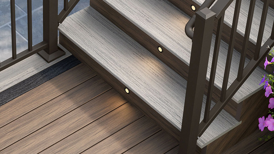 A close-up of composite deck stairs with lighting