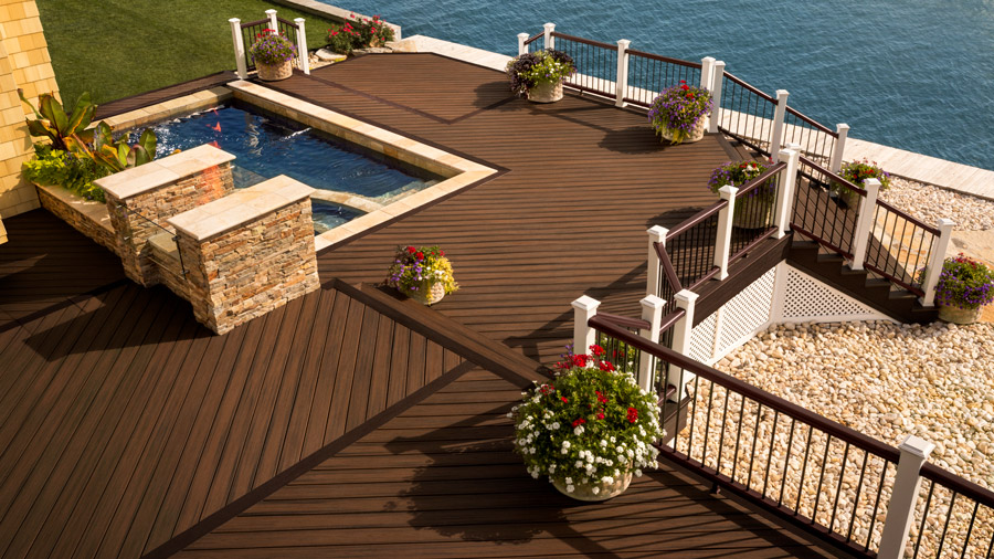 A large deck with several different sections using diagonal deck boards in an eye-catching pattern