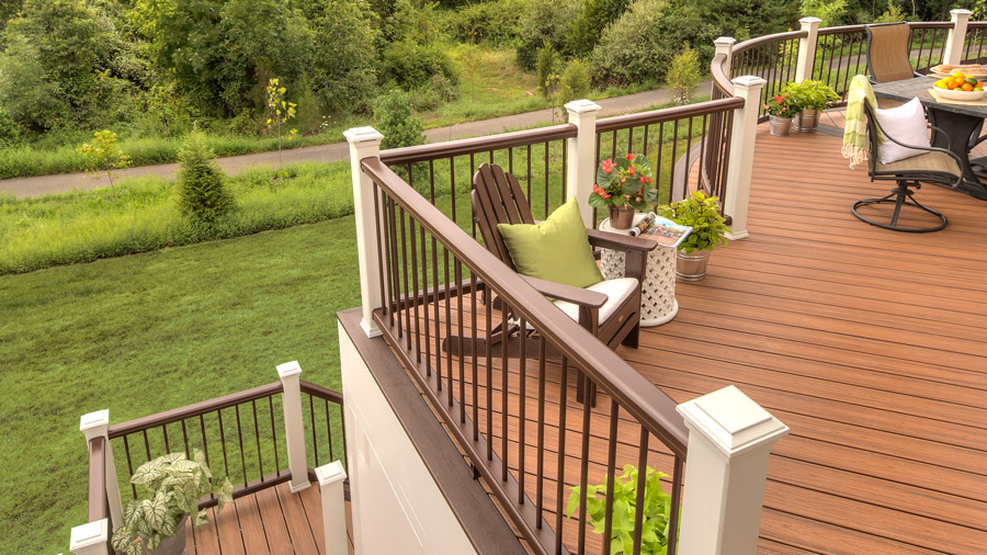 A totally traditional composite deck railing on a bright, summery deck
