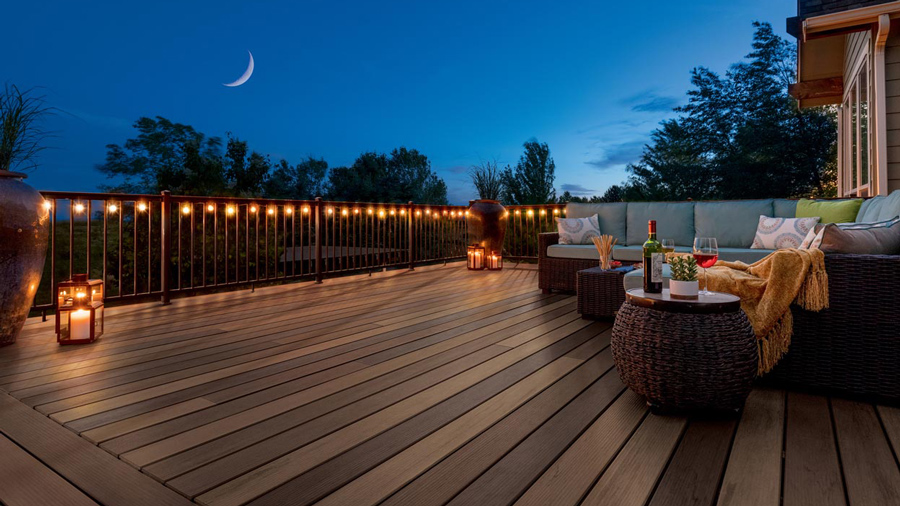 A classy night view of a deck mixing TimberTech's Pecan and Tigerwood colors