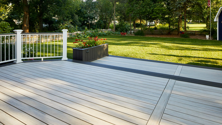 A deck with a stark dark and light contrast between the main decking surface and the picture frame around the edges
