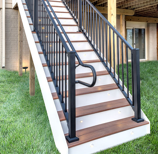A set of deck stairs with Trex handrail, including the looping handrail return