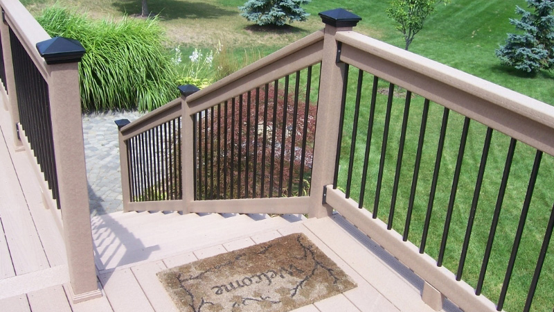 A wooden deck railing quickly refreshed with metal balusters and metal post caps